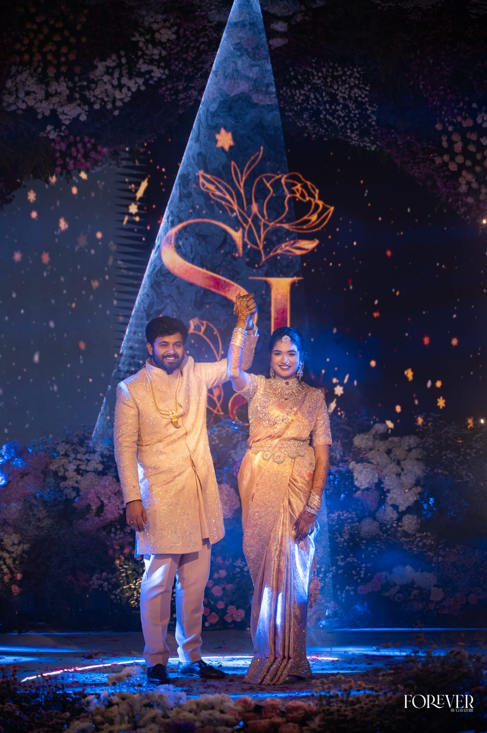 Sriya and Janak on the illuminated engagement stage